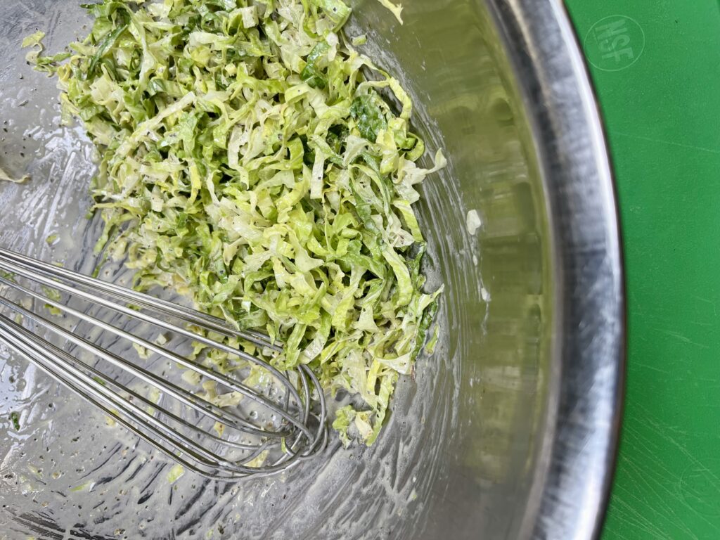 Dressed Shredded Lettuce in mixing bowl.