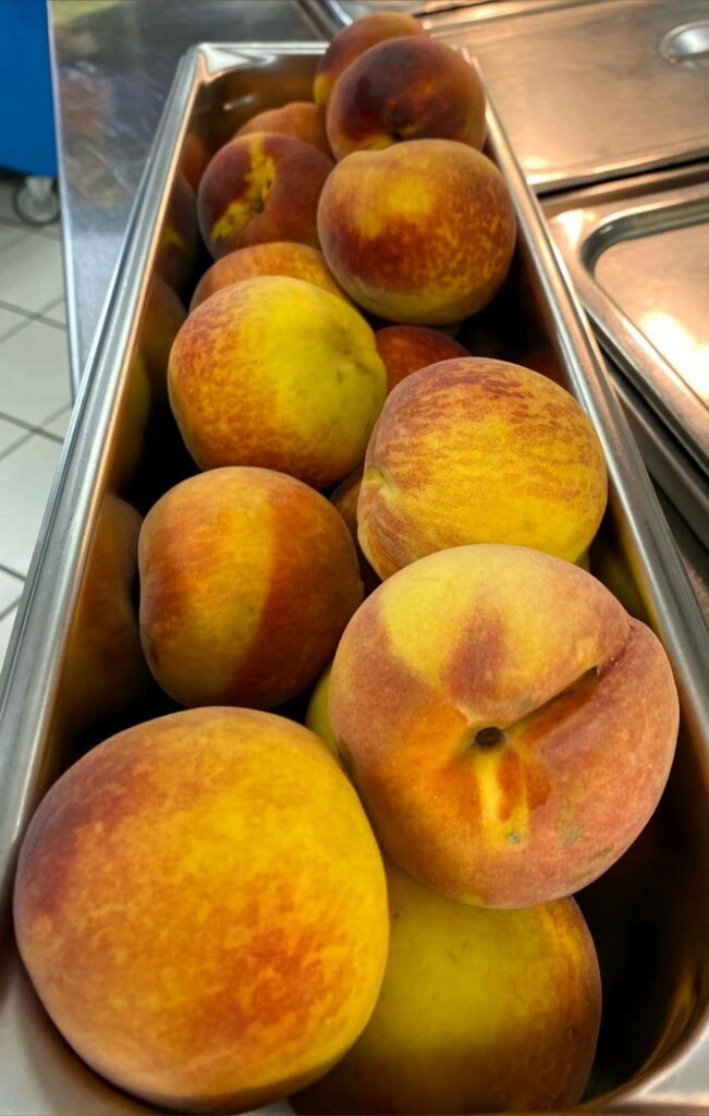 Peaches in 4-inch skinny pans for service.
