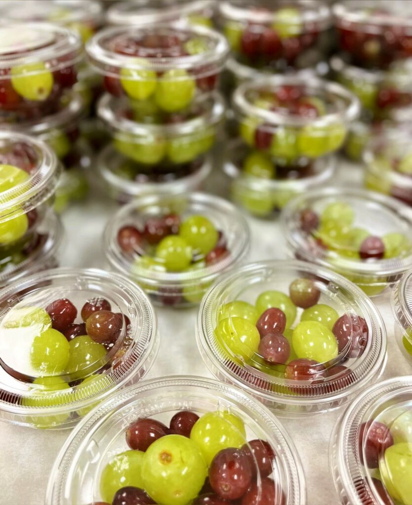 Grapes in clear containers for service.