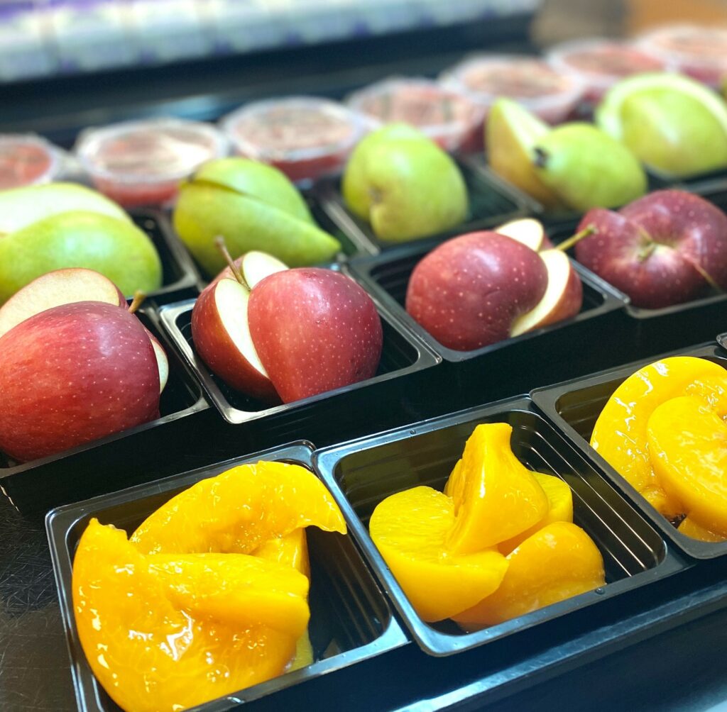 Portioned chilled peaches, apples, and pears.