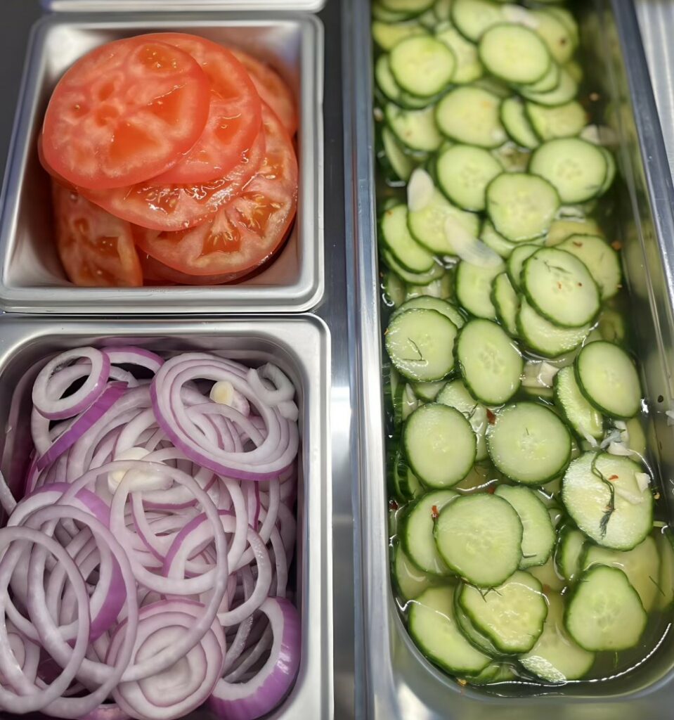 Sliced tomato, red onion, and house made pickles for toppings.