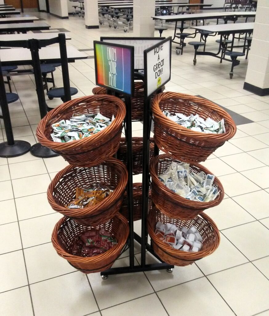Condiments displayed on lunch line.
