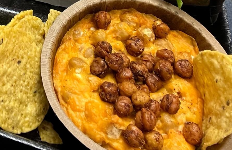 Buffalo Chickpea Dip with corn chips.