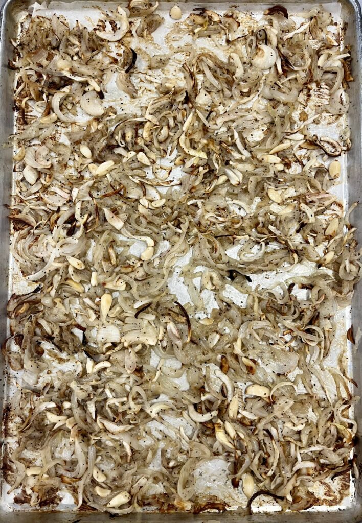 Slow Roasted Onions and Garlic on baking sheet.