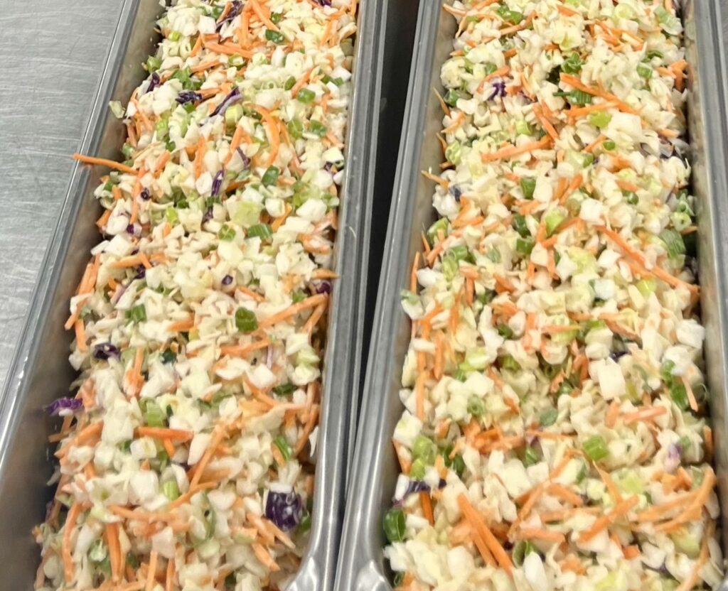 Creamy Cilantro-Lime Slaw in 4-inch pans for service.