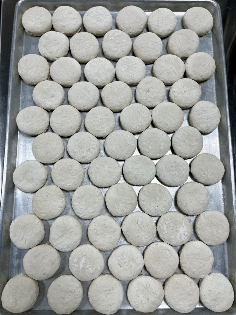 Frozen biscuits on baking sheet.