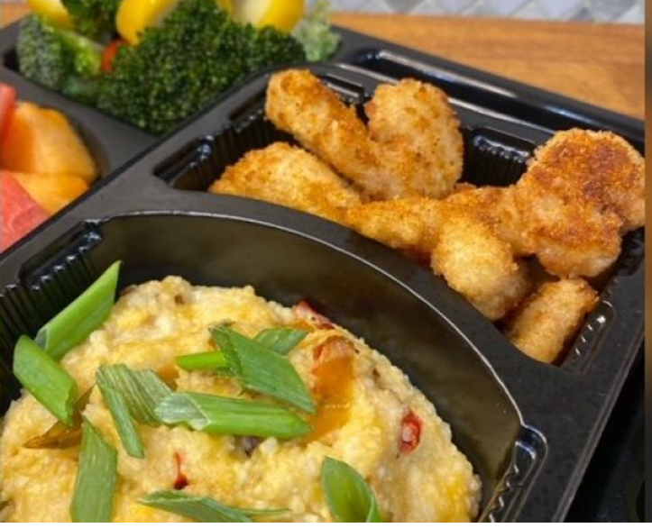 Shrimp and Grits on a tray.