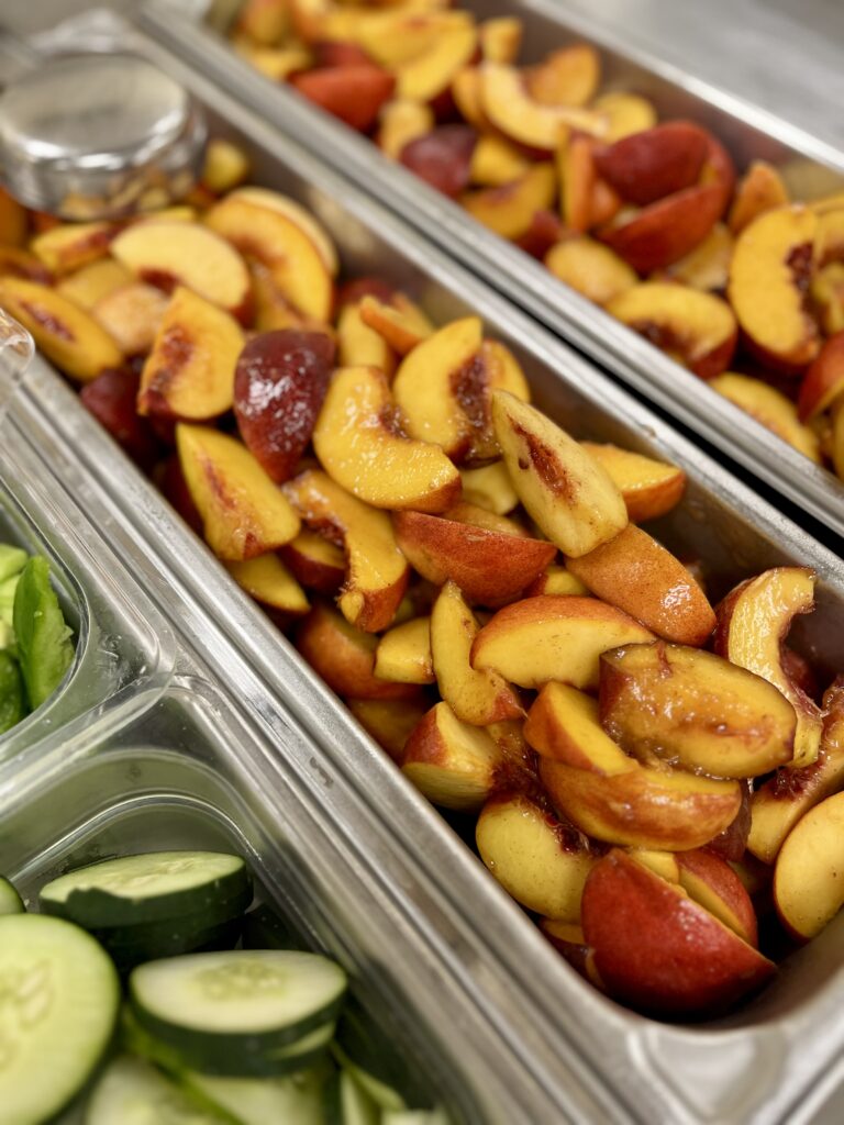 Peaches with Vanilla Honey in 4-inch skinny pans for service.