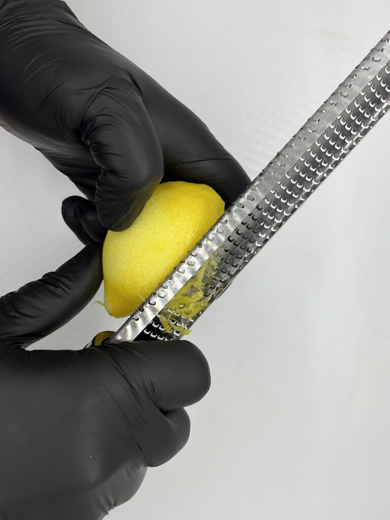 Zesting fresh lemon.