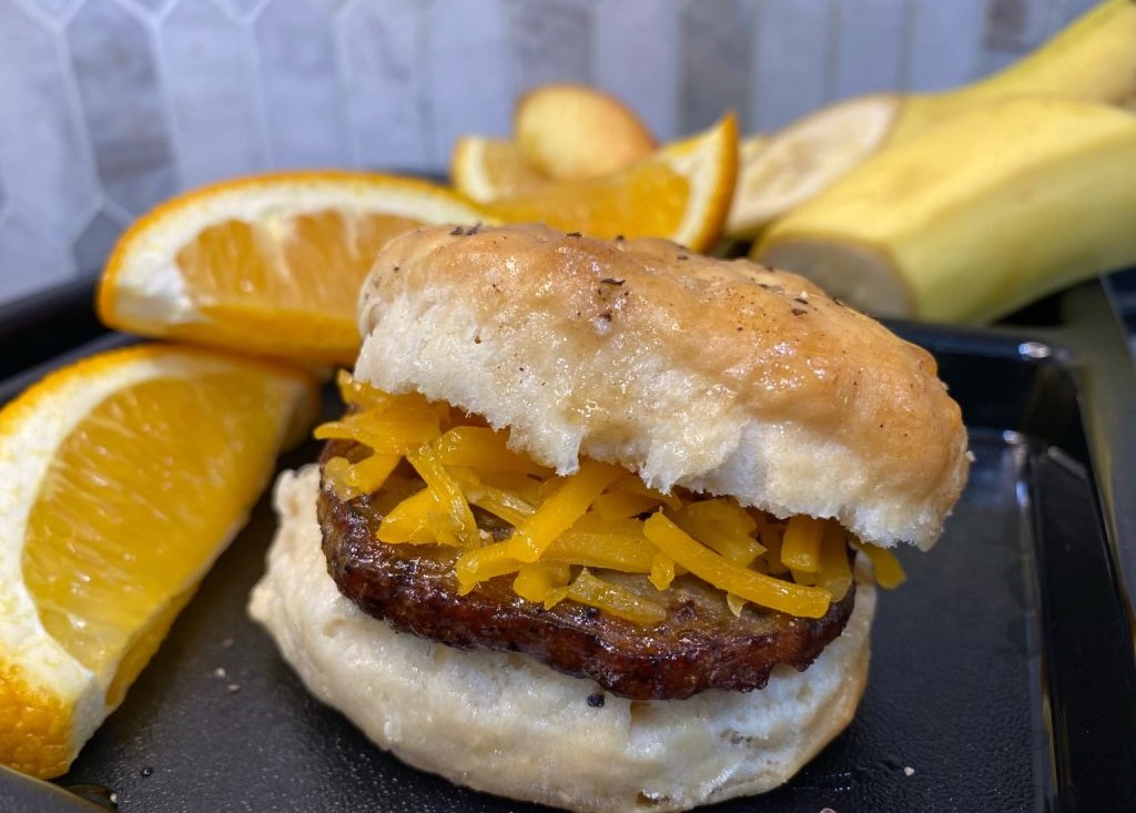 Honey Cheddar Sausage Biscuit with a side of fruit.