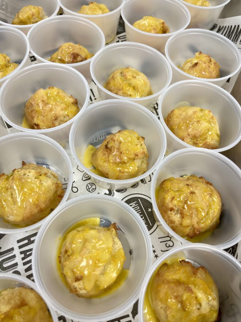 Satsuma Cardamom Drop Biscuits in cups with sauce.