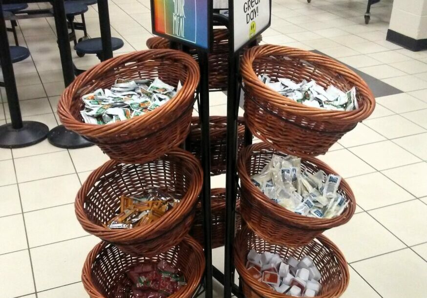 Condiments displayed on lunch line.