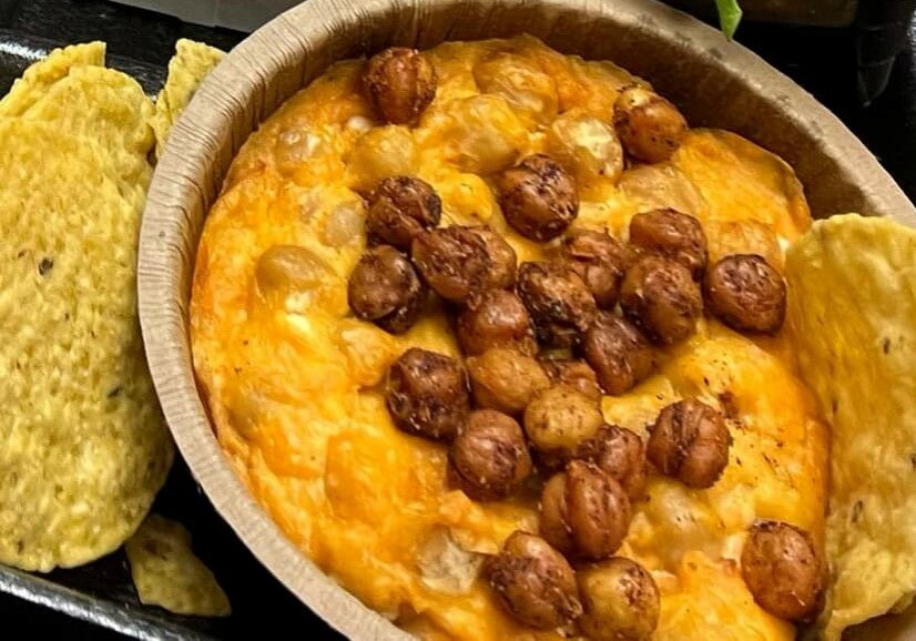 Buffalo Chickpea Dip with corn chips.