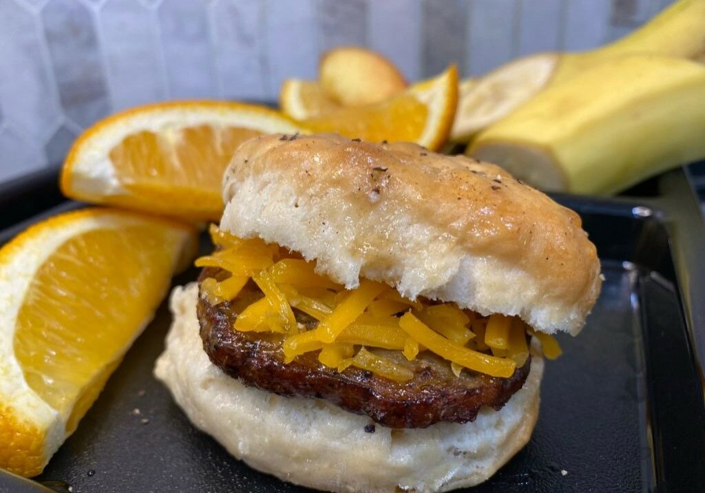 Honey Cheddar Sausage Biscuit with a side of fruit.