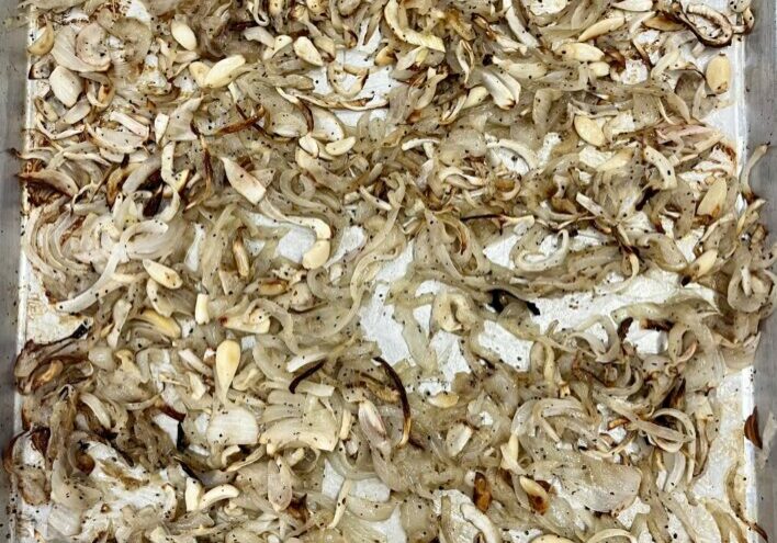 Slow Roasted Onions and Garlic on baking sheet.