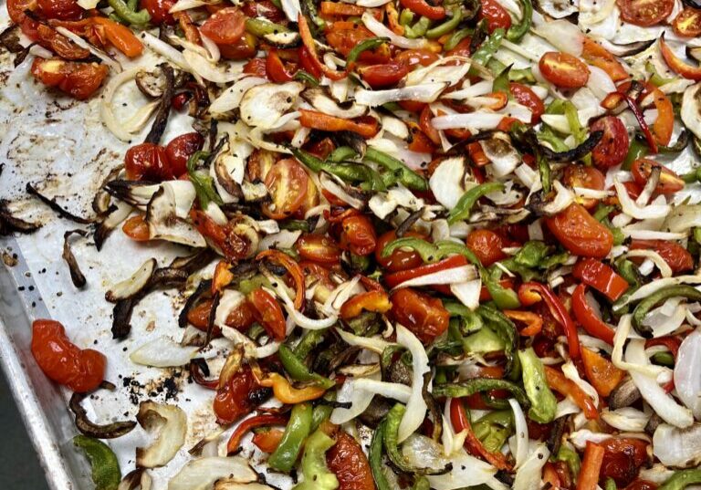 Roasted Onion, Bell Peppers, and Tomatoes on baking sheet.