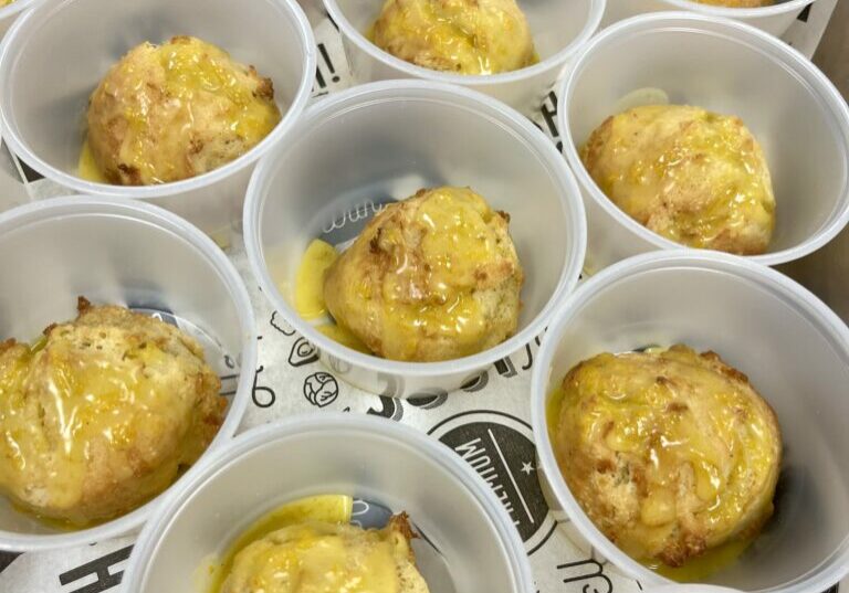 Satsuma Cardamom Drop Biscuits in cups with sauce.