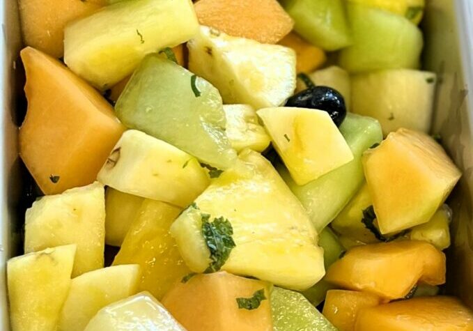 Honey Mint Citrus Dressing on Fruit Salad.