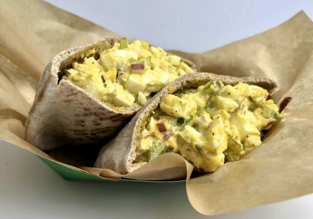 Jerk Egg Salad Pita sliced in a basket.